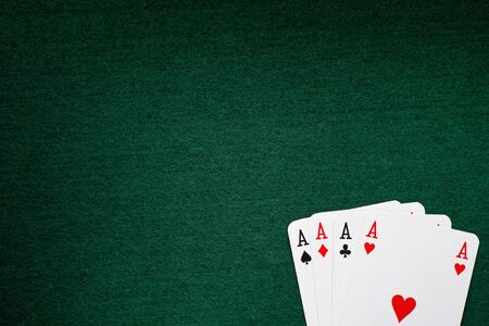Four aces on a green background.