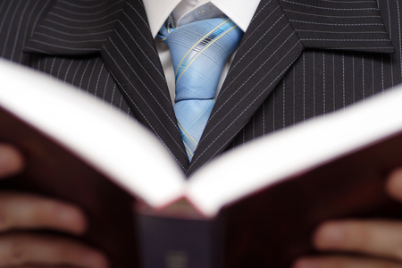 Businessman holding and reading bookの写真素材