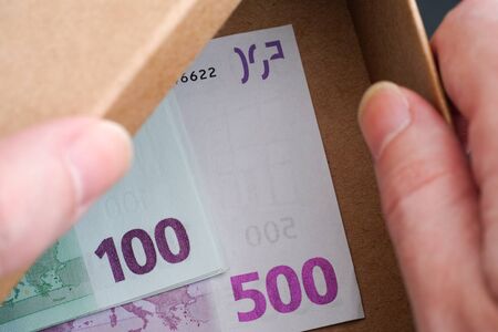 Hands open box with Euro banknotes in it. Conceptual image.