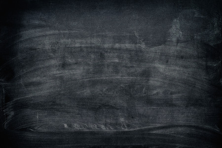 Black dirty chalkboard background. Vignette.の写真素材