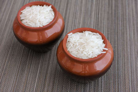 White rice in the clay pots. Close up.