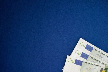 One hundred euro banknotes heap on a blue background. Vignette.の写真素材