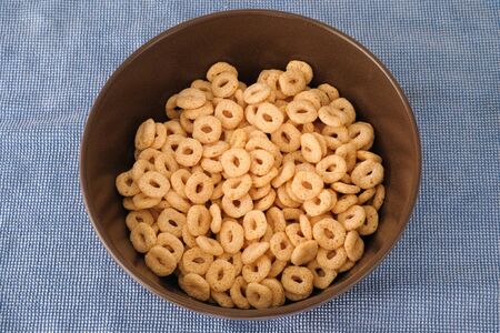 Gluten free whole grain rice and corn cereal loops in a bowl.