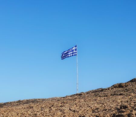 Greek flag waving over blue sky.の写真素材