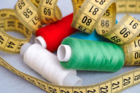 Tools for embroidery. Thread spools and tape measure. Closeup.の写真素材