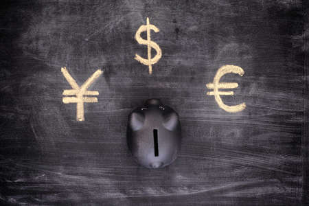 Black piggy bank and Currency signs (Euro, Dollar, Yen). Vignette.