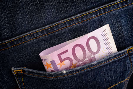 Five hundred euro banknote in back pocket of blue jeans. Close up.の写真素材