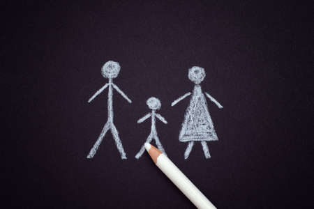 Family drawn by a pencil on black background. Close up.の写真素材