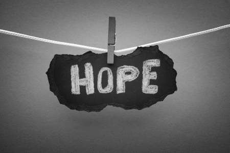 Word Hope on black piece of paper. Black and White. Close up.の写真素材
