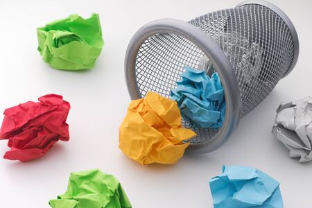 Colorful paper balls rolling out of trash can. Idea Concept.の写真素材