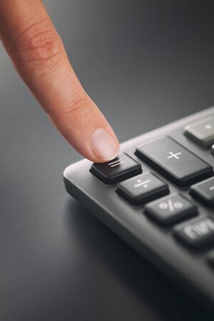 Person using calculator. Closeup.