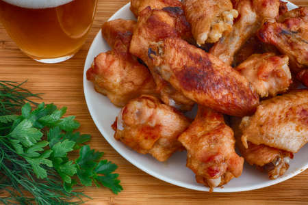 Baked chicken wings with beer and dill with parsley. Close up.の写真素材