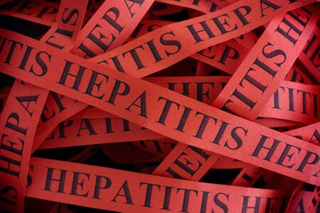 Hepatitis. Pieces of paper with the words Hepatitis. Concept Image. Closeup.の写真素材