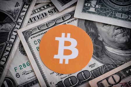 Bitcoin symbol on US dollars. Close up.の写真素材