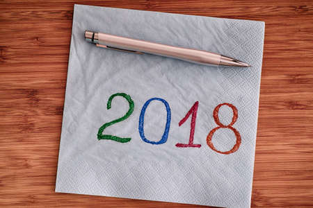 2018 handwriting on a napkin. Close up.