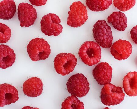 Ripe raspberries on a white plate. Close up.の写真素材