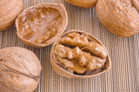 Cracked Walnut Near Others Walnuts. Close up.