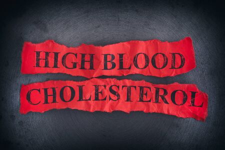 Crumpled pieces of paper with the words High Blood Cholesterol. Close up.の写真素材