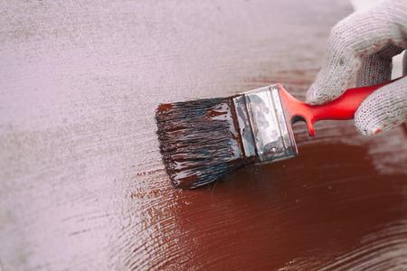 Hand painting wall brown. Close up.の写真素材