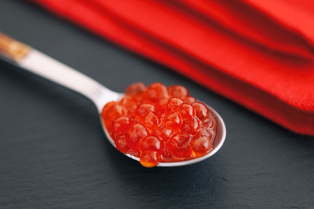 Salmon caviar in a spoon. Close up.の写真素材
