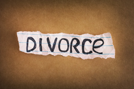 Divorce. Crumpled piece of paper with the word Divorce on brown paper background. Close up.の写真素材