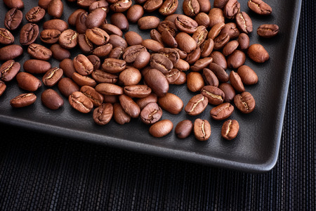 Roasted coffee beans. Low key. Close up.