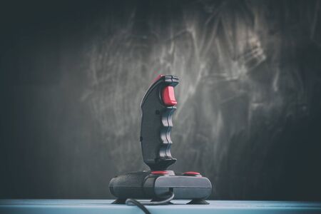 Gaming joystick from the mid-1980s. Joystick has dust particles and scratches.