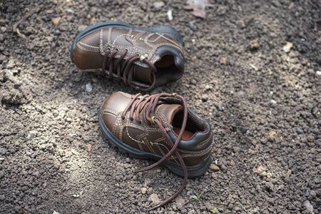 A pair of lost shoes. Missing kid or lost child concept.