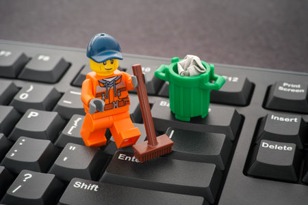 Tambov, Russian Federation - January 24, 2020 Lego minifigure cleaning keyboard with a broom.