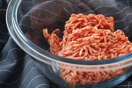 Minced beef in a glass bowl. Close up.