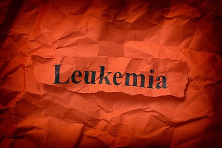 Torn piece of paper with the word Leukemia. Close up.の写真素材