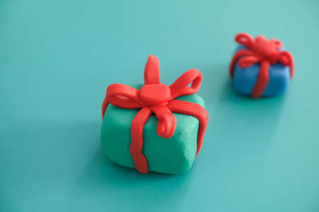 Play clay gift boxes wrapped with play clay ribbons. Close up.