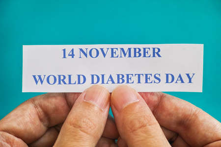 Person holding piece of paper with the words World Diabetes Day (14 November). Close up.の写真素材