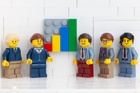 Tambov, Russian Federation - November 14, 2020 Lego minifigure businesspeople having a meeting in their office and showing the results of their successful teamwork.のeditorial素材