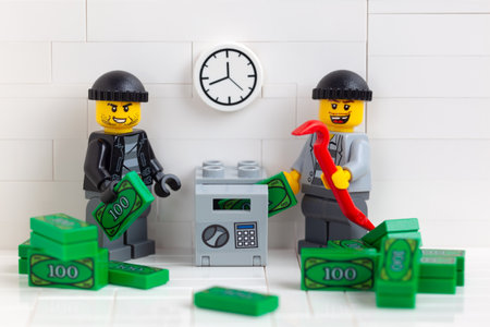 Tambov, Russian Federation - December 22, 2020 Two Lego minifigure robbers stealing money from a...