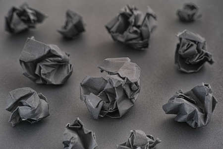 Crumpled black paper balls on a black background. Idea concept. Low key. Close up.
