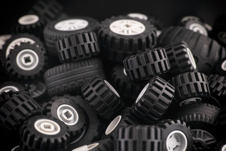 Tambov, Russian Federation - March 10, 2021 A heap of Lego wheels with some dust on them. Low key.のeditorial素材