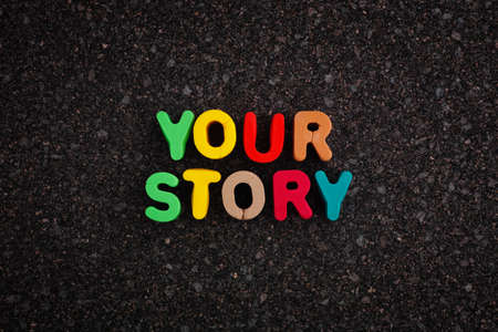 The phrase Your Story on a dark cork board. Close up.の写真素材