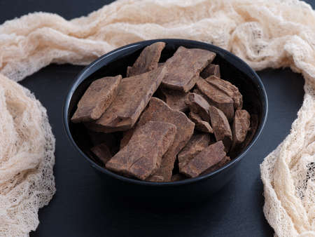 Cacao paste in a black bowl. Theobroma cacao. Low key.の写真素材