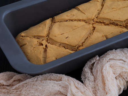 Freshly baked homemade gluten free bread in a baking tray. Close up.