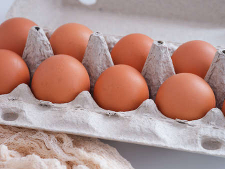 Organic brown chicken eggs in a carton. Close up.
