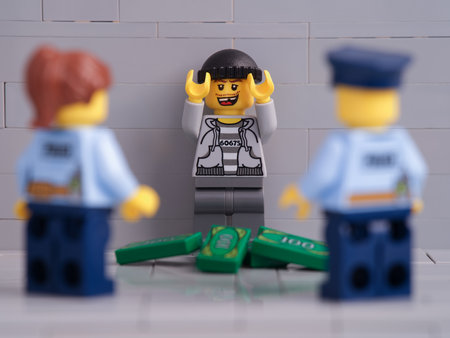 Tambov, Russian Federation - November 26, 2021 Two Lego police officer minifigures arresting a lego thief minifigure. Close up.のeditorial素材