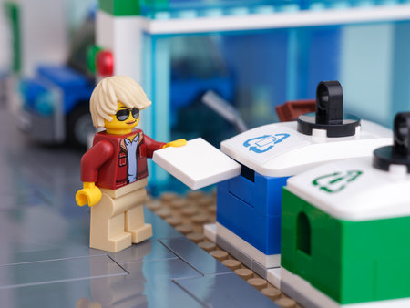 Tambov, Russian Federation - January 11, 2022 A Lego woman minifigure putting a piece of paper into...