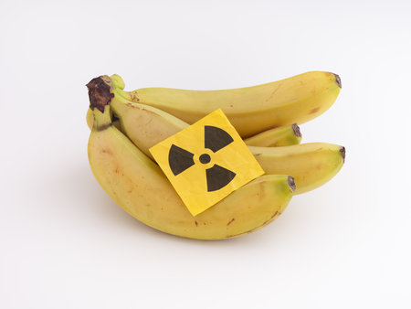 A bunch of bananas with a radiation warning sign on them. close up.の写真素材