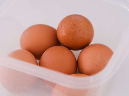 Hard boiled eggs in a plastic container. Close up.の写真素材