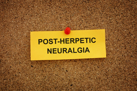 A yellow paper note with the words Post-Herpetic Neuralgia on it pinned to a cork board. Close up.の写真素材