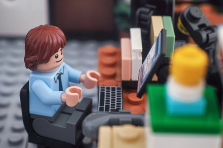 Tambov, Russian Federation - August 04, 2023 A Lego businessman minifigure working on a computer in an office. Close up.のeditorial素材