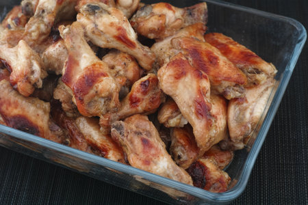 Baked chicken wings in a glass container. Close up.の写真素材