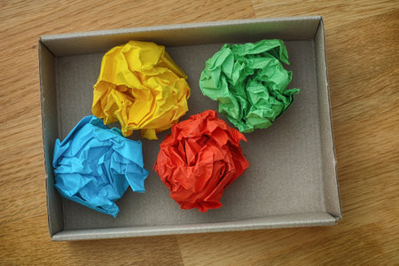 Colorful crumpled paper balls in a cardboard box. Idea Concept. Close up.の写真素材