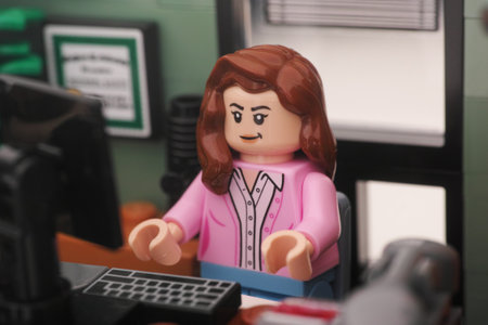 Tambov, Russian Federation - November 01, 2023 A Lego businesswoman minifigure sitting and working behind a computer in an office. Close up.のeditorial素材